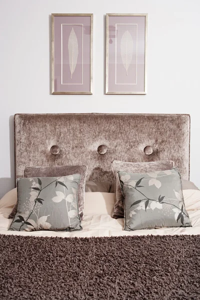 Bed head in an elegant hotel double bedroom — Stock Photo, Image