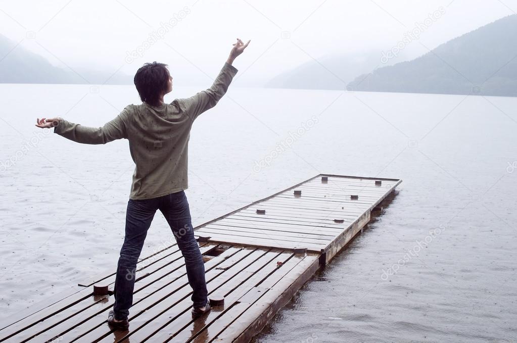 Man standing on a wooden pier