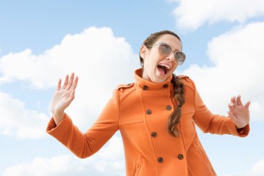 Woman shouting and holding her arms in the air clipart