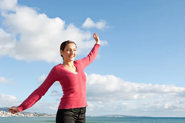 Woman feeling happy and raising her arms — Stock Photo, Image