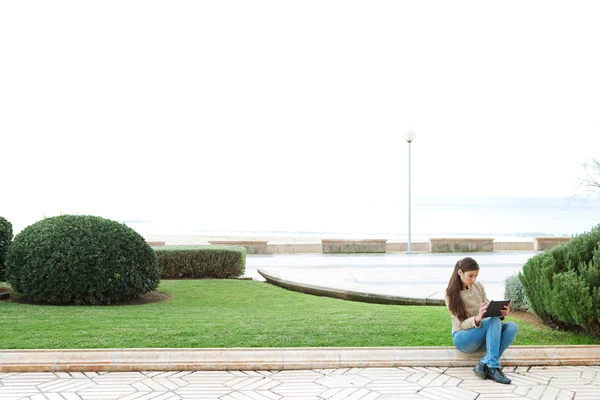 Woman sitting down on a stone step — Stock Photo, Image