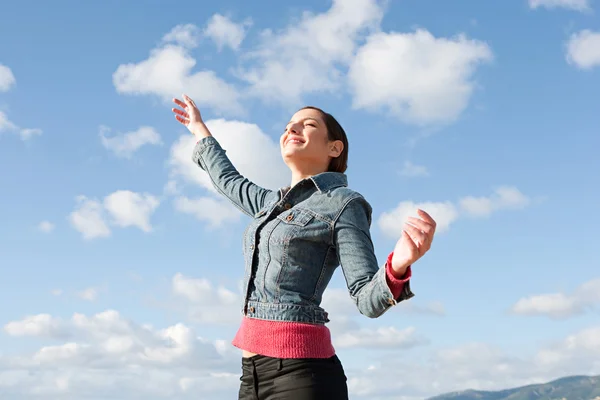 Woman feeling happy and raising her arms — Stock Photo, Image