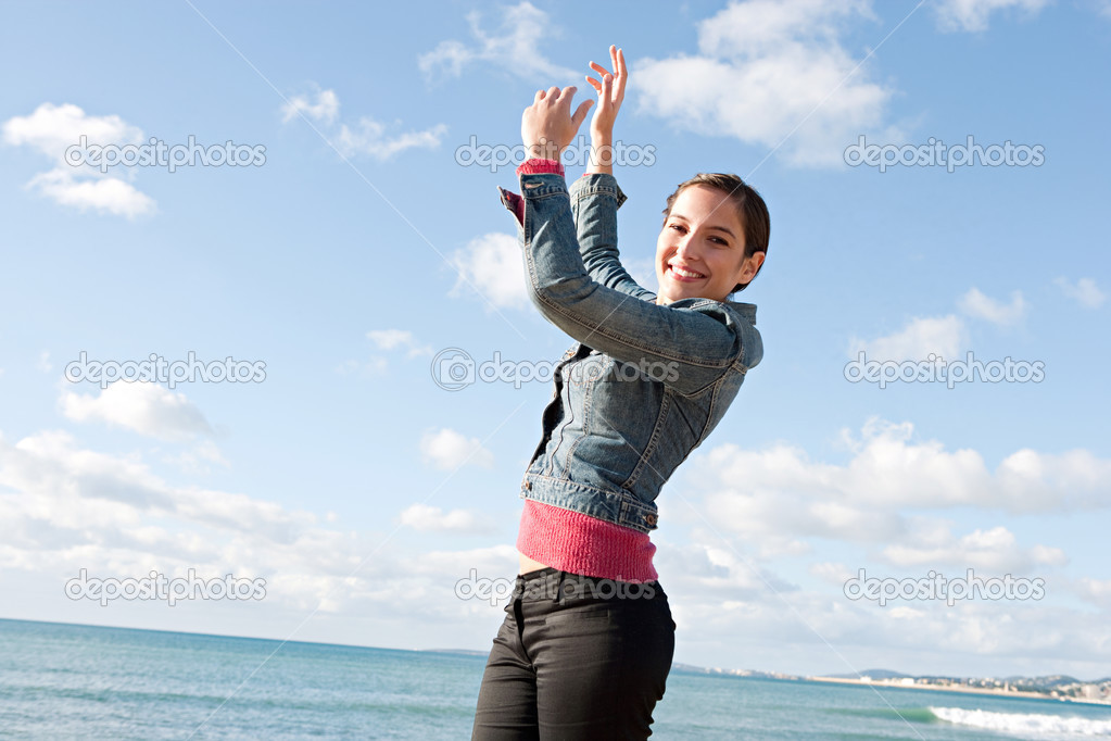 Woman feeling happy and raising her arms