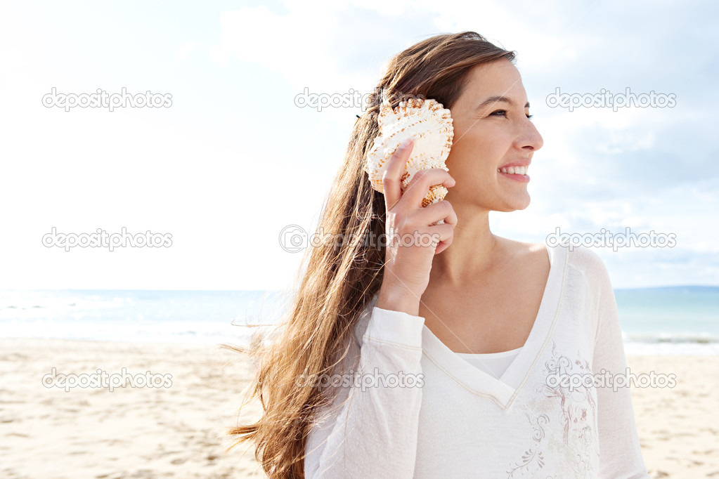 woman holding a sea shell