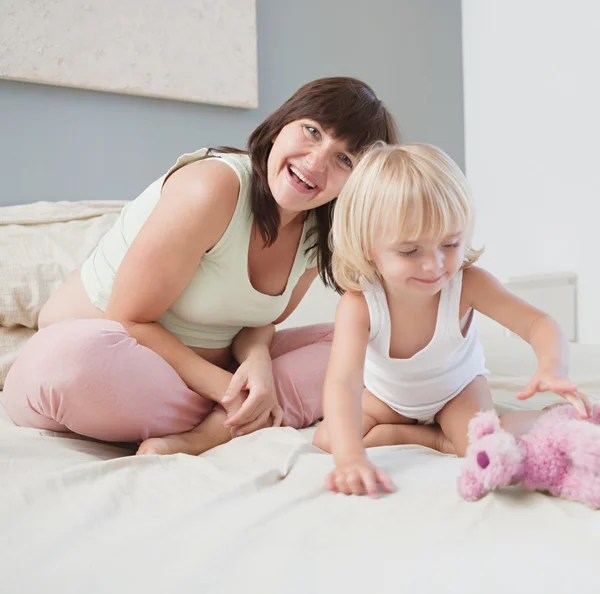 Pregnant woman and child daughter playing — Stock Photo, Image