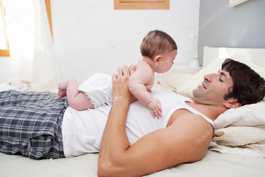 Father holding his new born baby daughter