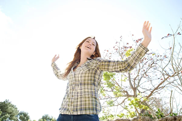 Woman being playful with her arms outstretched — Stock Photo, Image