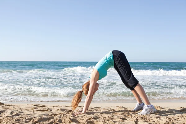 Woman stretching her legs and back — Stock Photo, Image