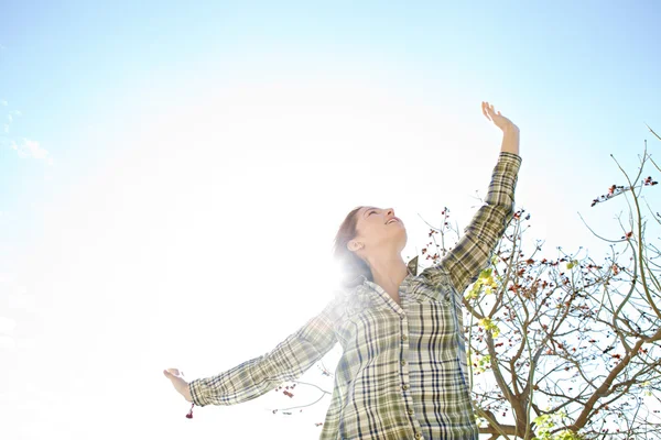 Woman being playful with her arms outstretched Stock Image
