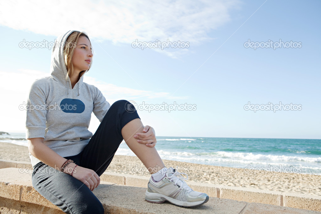 Woman sitting by a beach