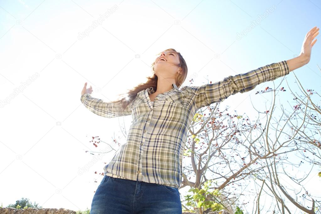 Woman being playful with her arms outstretched