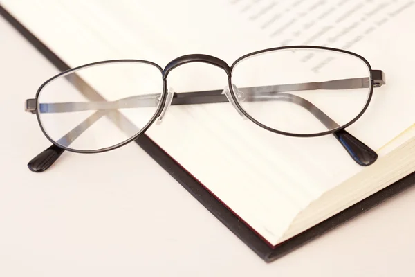 Lunettes de lecture posées sur le livre — Photo