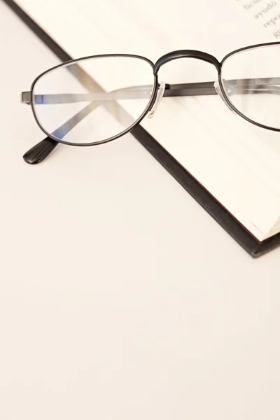 Reading glasses laying on the book — Stock Photo, Image