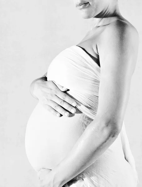 Pregnant woman holding her belly — Stock Photo, Image