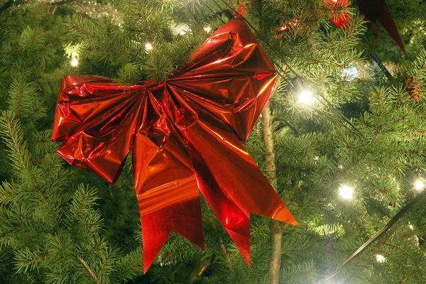 Grande red ribbon on Christmas tree — Stock Photo, Image