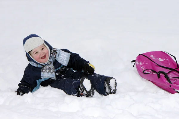 Baby in winter with bobsleigh. — Stock Photo, Image