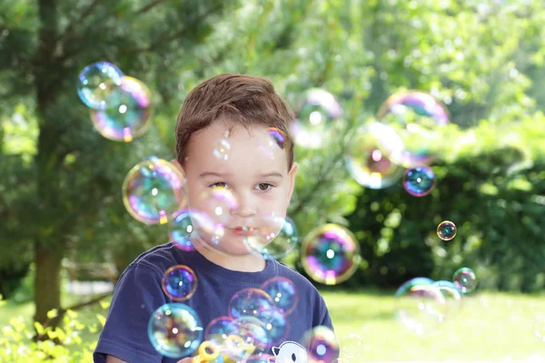 Boy blowing bubbles — Stock Photo, Image