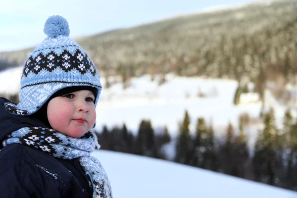 Boy in winter on mountains — Stock Photo, Image