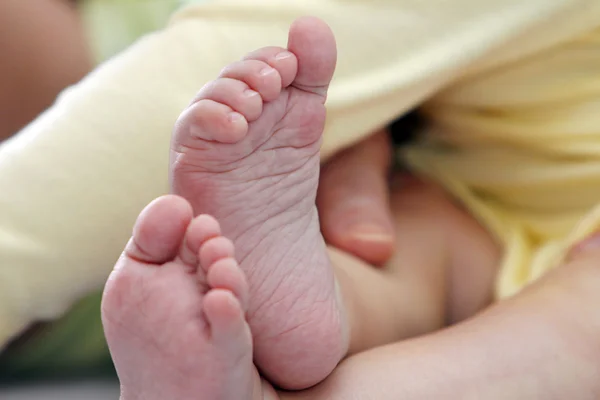 Madre sosteniendo los pies del niño — Foto de Stock