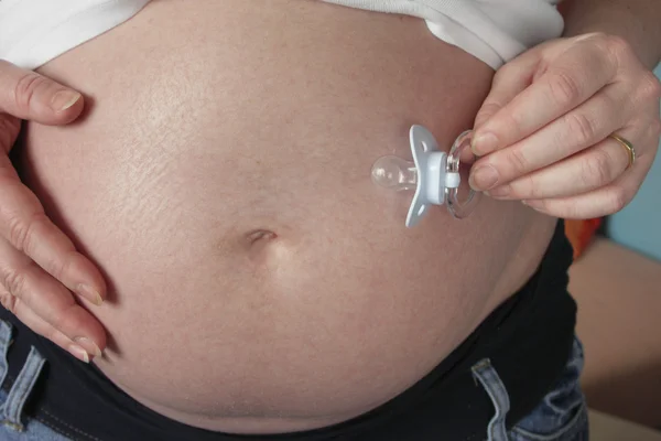 Pregnant women with dummy — Stock Photo, Image