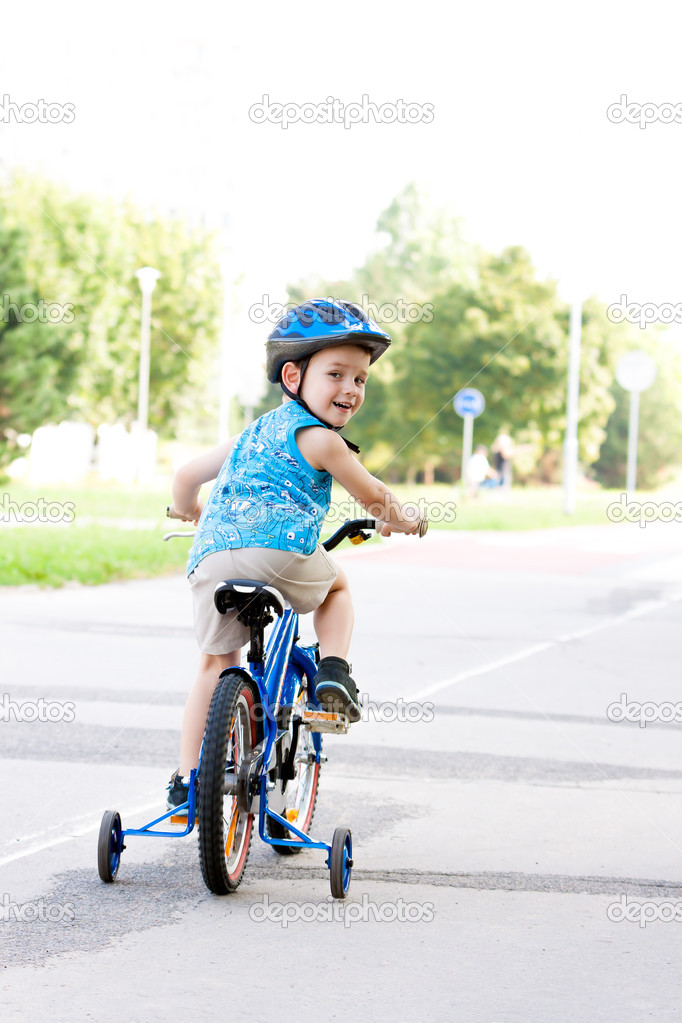 Baby boy on bike with crash helmet
