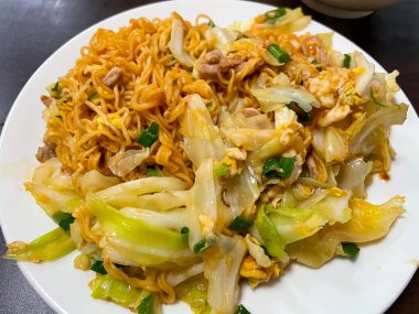 Fried noodles with vegetable on the white dish