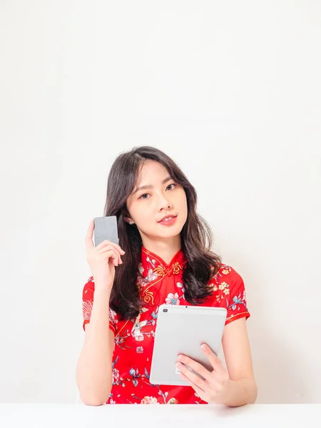 亚洲女青年穿着传统旗袍 在网上使用数码平板电脑和信用卡购物 电子商务概念与白人背景隔离 — 图库照片