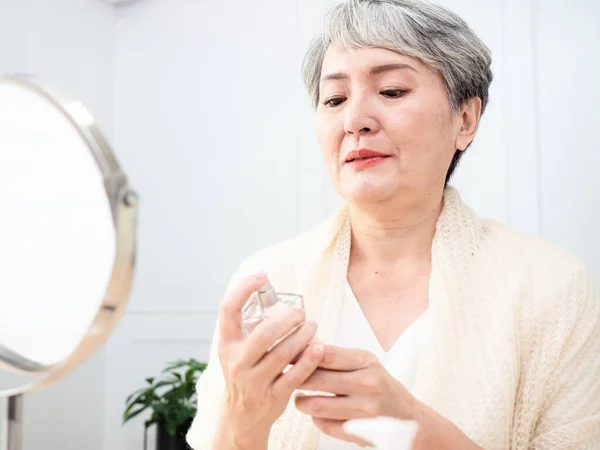 Portrait Mature Aged Asian Woman 60S Sprays Perfume — Fotografia de Stock