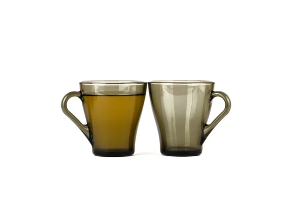 Two transparent cups, one with tea, the second blank — Stock Photo, Image