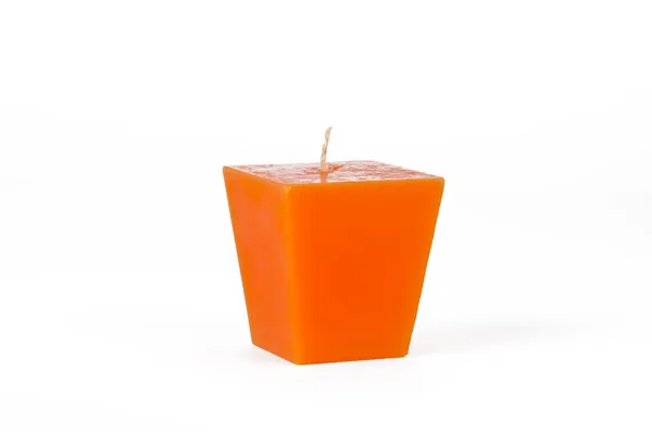 Vela trapezoide laranja com um pavio — Fotografia de Stock