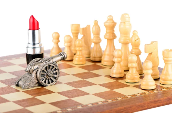 Chessmen, lipstick and a gun — Stock Photo, Image