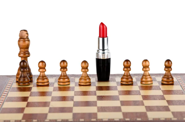 Red lipstick on a chessboard — Stock Photo, Image