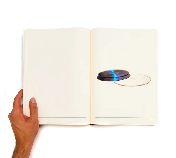 Два компакт-диска, напечатанных на белой книге . — стоковое фото