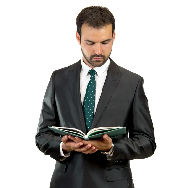 Hombre de negocios leyendo un libro sobre un fondo aislado — Foto de Stock