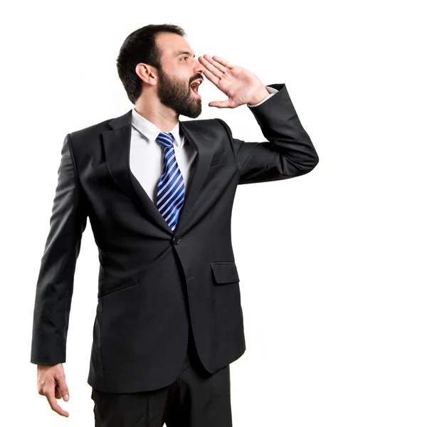 Joven hombre de negocios gritando sobre fondo blanco — Foto de Stock