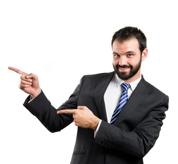 Affärsman som pekar åt sidan över vit bakgrund — Stockfoto