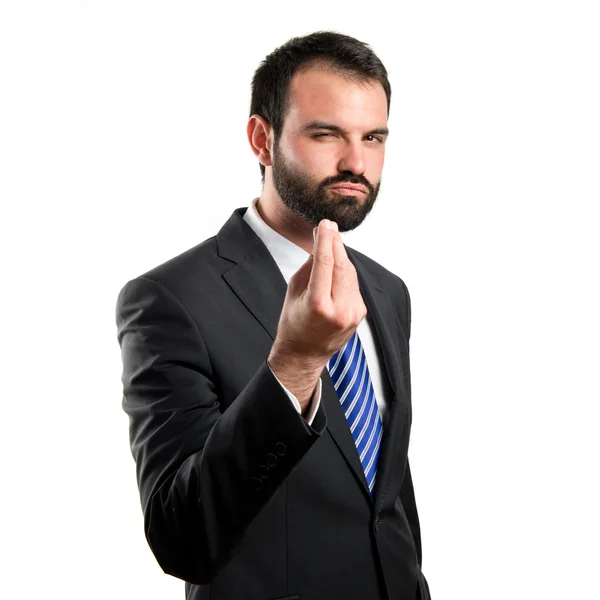 Giovane uomo d'affari che fa un gesto di soldi su sfondo bianco — Foto Stock