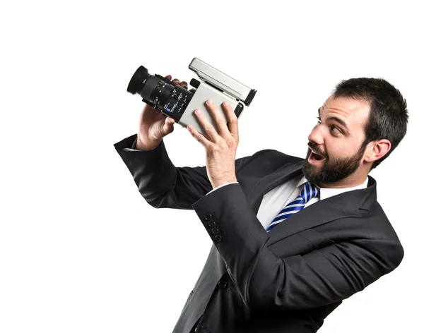 Fiatal üzletember videofelvétel felett fehér háttér — Stock Fotó