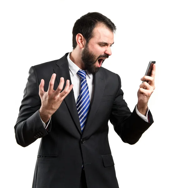 Young businessmen shouting to mobile over isolated background. — Stock Photo, Image