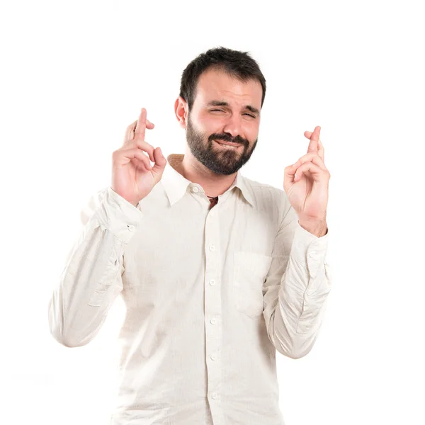 Jeune homme avec les doigts croisés sur fond blanc — Photo