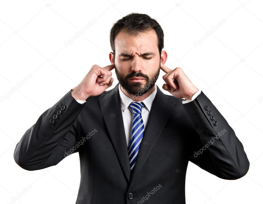 business man covering her ears over white background