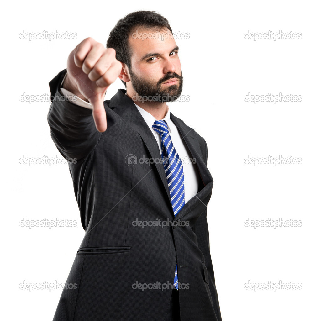 Young businessman with his thumb down over white background