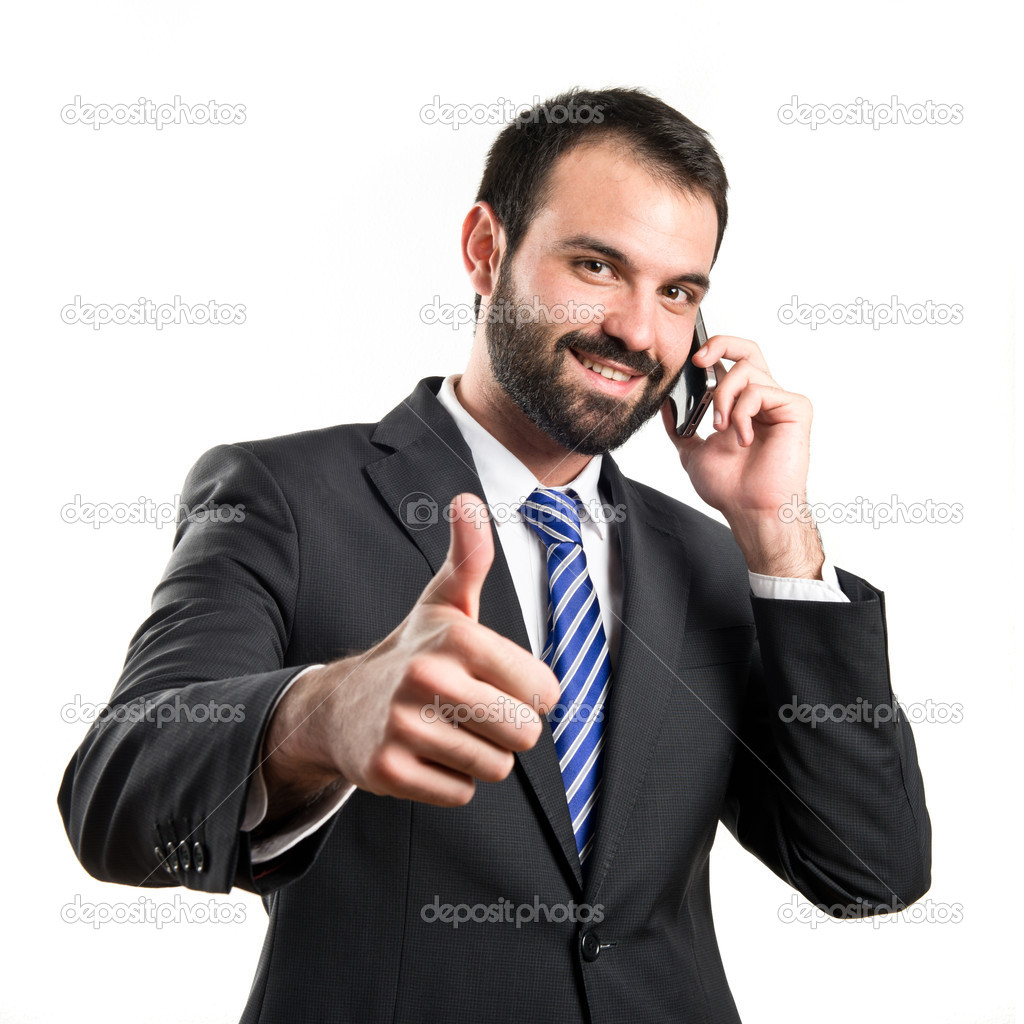 Young businessmen talking to mobile over isolated background.
