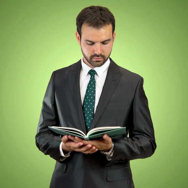 Business man reading a book over isolated background — Stock Photo, Image