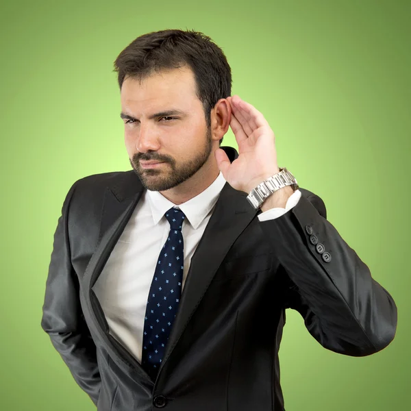 Jovem homem de negócios ouvindo algo — Fotografia de Stock