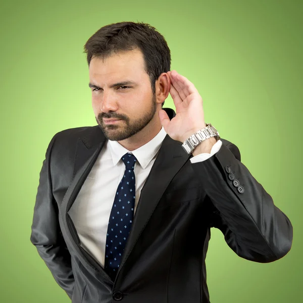 Joven hombre de negocios escuchando algo — Foto de Stock