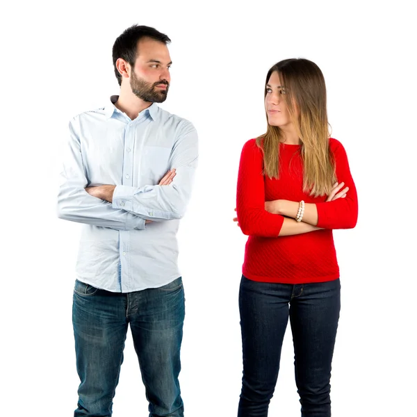 Couple with their arms crossed over isolated background — Stock Photo, Image