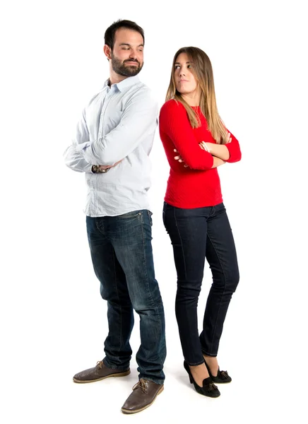Couple with their arms crossed over isolated background — Stock Photo, Image