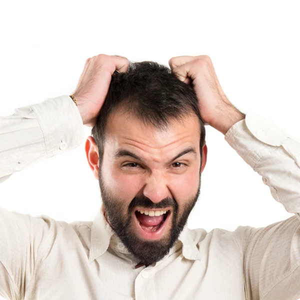 Young man furious over white background — Stock Photo, Image