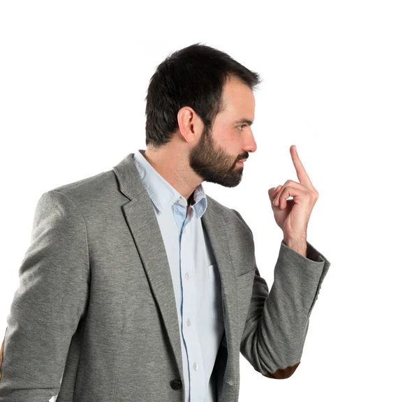 Joven hombre de negocios haciendo el signo de cuerno sobre fondo blanco — Foto de Stock